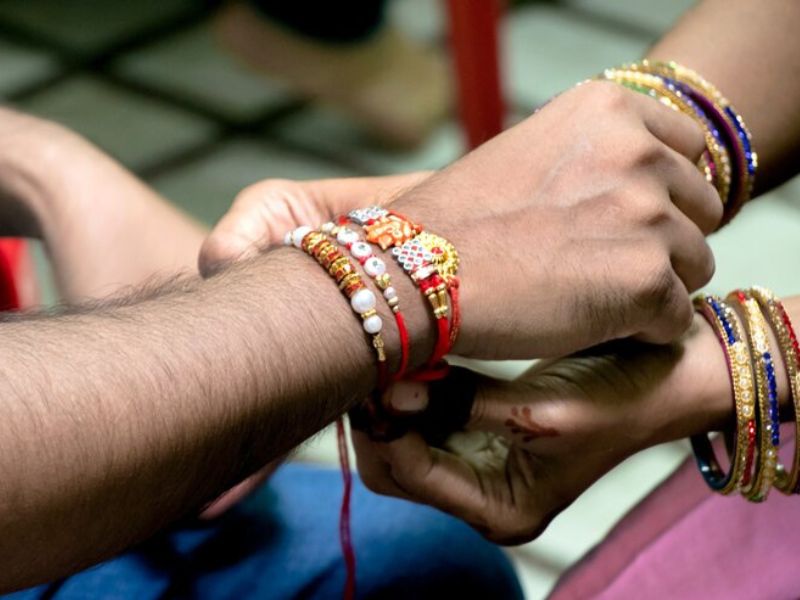 Touching Raksha Bandhan Quotes to Celebrate Sibling Love Wordsmithh Blog Handwritten Quote on a Raksha Bandhan Card with Diya and Rakhi